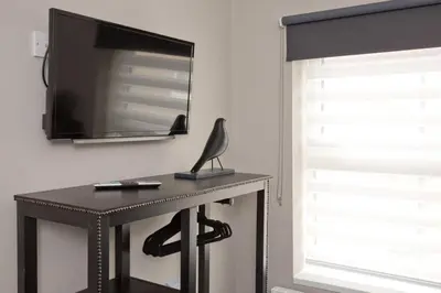 a black desk with a television on a wall at Blackbird Luxury 2 Bed Accomodation Room 8 in Blackpool