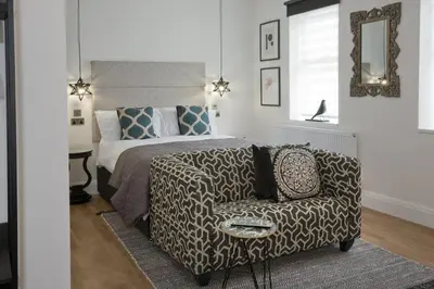 a bedroom with a bed and a couch and a chair at Blackbird Luxury Accommodation Studio Room 9 in Blackpool