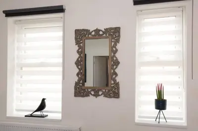 a black bird sitting on a window sill in front of a mirror at Blackbird Luxury Accommodation Studio Room 9 in Blackpool
