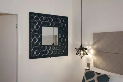 a mirror on a wall in a room with a bed at Blackbird Luxury Accommodation Studio Room 9 in Blackpool