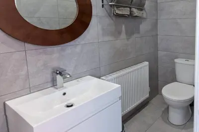 a bathroom with a sink and a toilet and a mirror at Blackbird Luxury Accommodation Room 10 in Blackpool