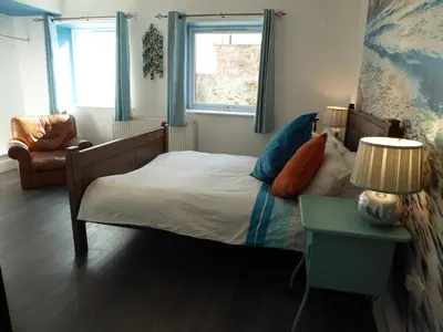 a bedroom with a bed and a table and a chair at The Myriad in Preston