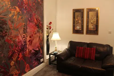 a living room with a couch and a large painting at The Myriad in Preston