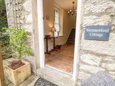 a sign on the side of a building that reads westmont college at Westmorland Cottage in Grange Over Sands