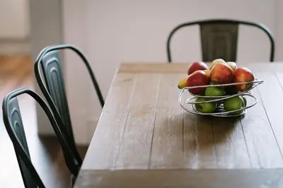 a bowl of apples on a wooden table at Period Retreat for 6, explore the Lake District in Lancaster