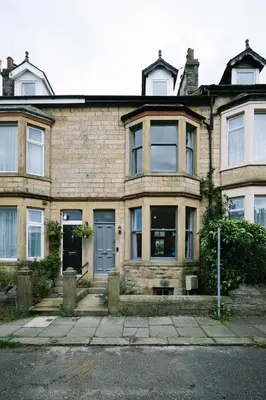 an old brick house with a blue door at Period Retreat for 6, explore the Lake District in Lancaster
