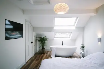 a bathroom with a bath tub in a bedroom at Period Retreat for 6, explore the Lake District in Lancaster