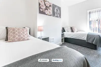 a bedroom with two beds and a window at Spacious 3 BR House in PR6 Free Parking & WiFi Sleeps 6 in Chorley