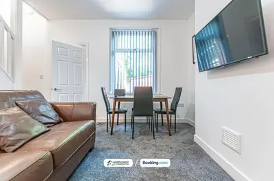 a living room with a couch and a table at Spacious 3 BR House in PR6 Free Parking & WiFi Sleeps 6 in Chorley
