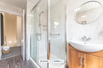a bathroom with a sink and a shower at Spacious 3 BR House in PR6 Free Parking & WiFi Sleeps 6 in Chorley
