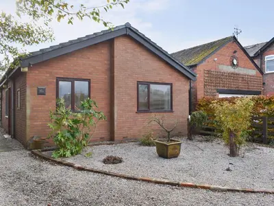 a brick house with a garden in front of it at Belmont in Longton