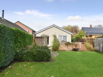 a garden with a house and a hedge at Belmont in Longton