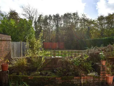 a garden with a fence and some plants at Belmont in Longton