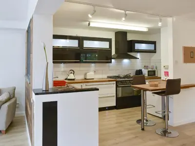 a kitchen with a counter and a table in it at Belmont in Longton