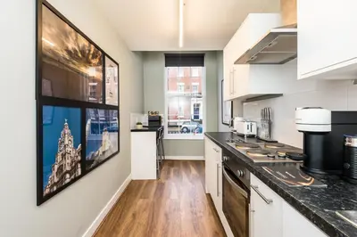 a kitchen with white cabinets and a counter top at Host & Stay - Canning Quarters in Liverpool