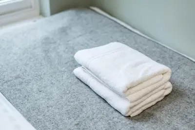 a stack of white towels sitting on a bathroom counter at Host & Stay - Canning Quarters in Liverpool