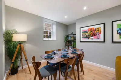 a dining room with a wooden table and chairs at Host & Stay - Catharine Quarters in Liverpool