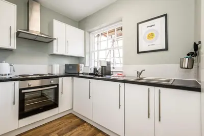 a kitchen with white cabinets and a sink at Host & Stay - Catharine Quarters in Liverpool