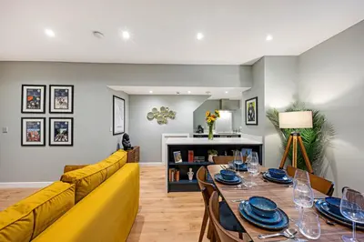 a living room with a yellow couch and a table at Host & Stay - Catharine Quarters in Liverpool