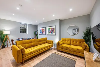 a living room with two yellow couches and a table at Host & Stay - Catharine Quarters in Liverpool