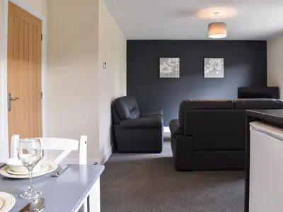 a living room with a couch and a chair at One Dorchester Drive - Uk32037 in Inglewhite