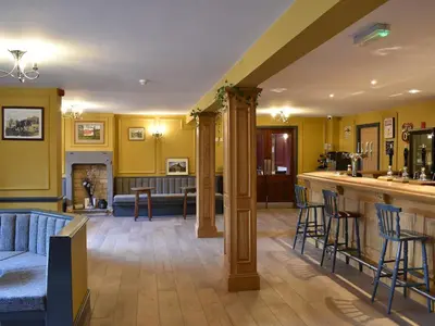 a living room with a bar and a couch at Five Dorchester Drive - Uk32043 in Inglewhite