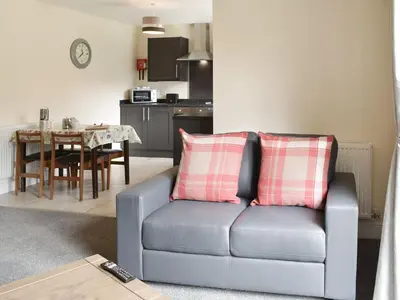 a living room with a couch and a table at Five Dorchester Drive - Uk32043 in Inglewhite