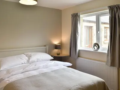 a bedroom with a white bed and a window at Five Dorchester Drive - Uk32043 in Inglewhite