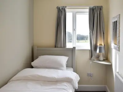 a bedroom with two beds and a window at Five Dorchester Drive - Uk32043 in Inglewhite