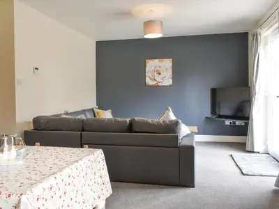 a living room with a couch and a table at Three Dorchester Drive - Uk32039 in Inglewhite