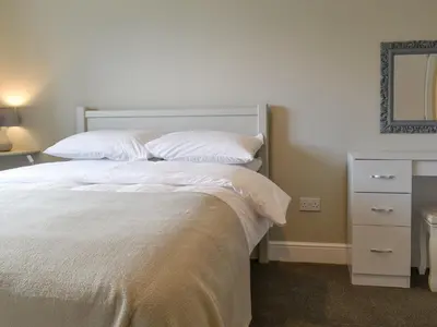 a bedroom with a bed with white sheets and pillows at Three Dorchester Drive - Uk32039 in Inglewhite