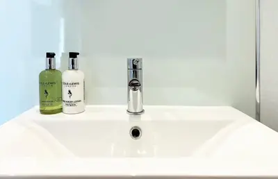 a white sink with two bottles of wine on it at The Pheasant Inn in Grange Over Sands