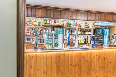 a bar with a lot of bottles of alcohol at The Pheasant Inn in Grange Over Sands