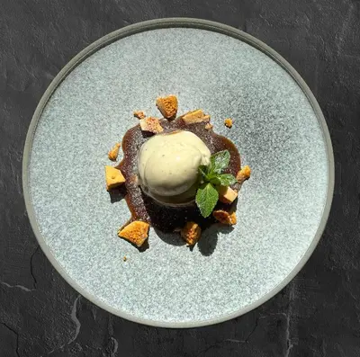 a plate with a dessert with ice cream on it at The Pheasant Inn in Grange Over Sands