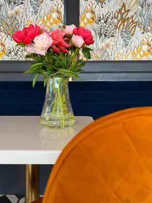 a vase of flowers sitting on top of a table at The Pheasant Inn in Grange Over Sands