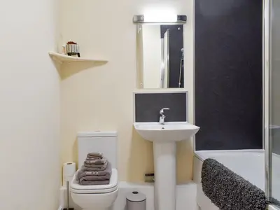 a bathroom with a sink and a toilet and a mirror at Two Dorchester Drive - Uk32036 in Inglewhite