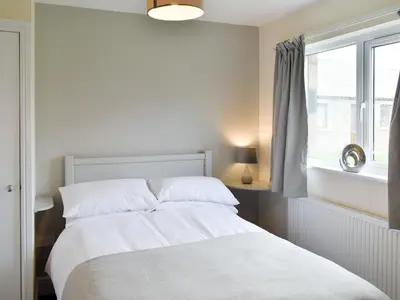 a white bedroom with a bed and a window at Four Dorchester Drive - Uk32042 in Inglewhite