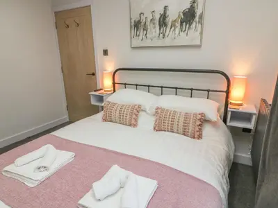 a bedroom with a bed with towels on it at Box Tree Escapes in Lancaster