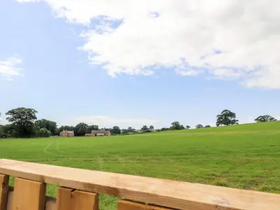 a view of a field from a wooden bench at Box Tree Escapes in Lancaster