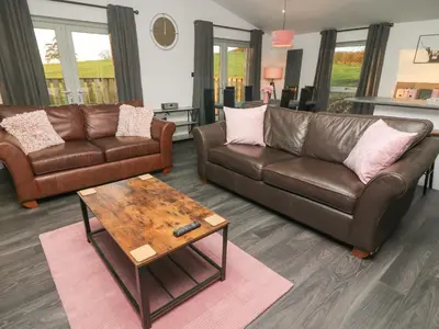 a living room with two couches and a coffee table at Box Tree Escapes in Lancaster
