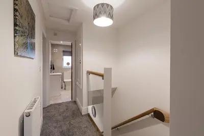 a white hallway with a staircase and a bathroom at Tannery Place - 3 Bedrooms Parking Wi-Fi Garden in Freckleton
