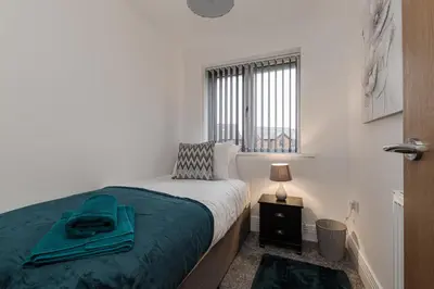 a white bedroom with a bed and a window at Tannery Place - 3 Bedrooms Parking Wi-Fi Garden in Freckleton