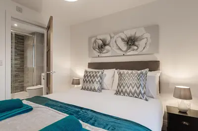 a bedroom with a large white bed with pillows at Tannery Place - 3 Bedrooms Parking Wi-Fi Garden in Freckleton