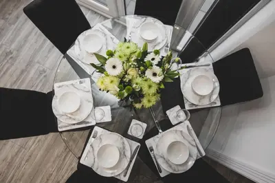 a table with white plates and a vase of flowers at Tannery House - 3 Bedrooms, Parking, Wi-Fi, Garden in Freckleton