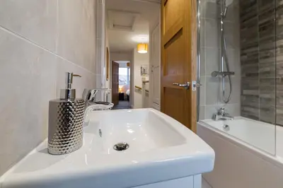 a white bathroom with a sink and a shower at Tannery House - 3 Bedrooms, Parking, Wi-Fi, Garden in Freckleton