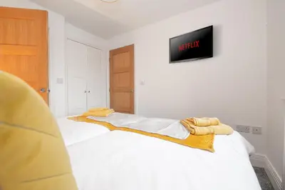 a bedroom with a bed with a tv on the wall at Tannery House - 3 Bedrooms, Parking, Wi-Fi, Garden in Freckleton