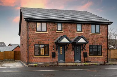 a red brick house with a black roof at Tannery House - 3 Bedrooms, Parking, Wi-Fi, Garden in Freckleton