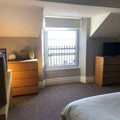 a bedroom with a bed and a window at The View in Grange Over Sands