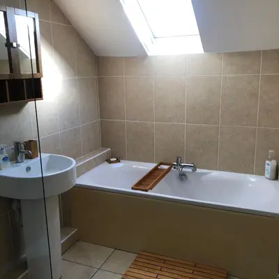 a bathroom with a bath tub and a sink at The View in Grange Over Sands