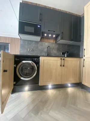 a kitchen with a washing machine in a kitchen at Eleanor Rigby apts Stanley Street in Liverpool